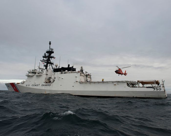 1280px-A_U.S._Coast_Guard_MH-65_Dolphin_helicopter_flies_by_the_national_security_cutter_USCGC_Bertholf_(WMSL_750)_in_the_Arctic_Ocean_Sept_120914-G-VS714-527